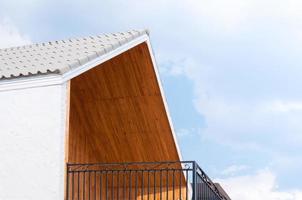 Wooden gabled roof with blue sky,triangles roof house sky background photo