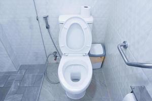 Toilet bowl in a modern bathroom with bins and toilet paper,flush toilet clean bathroom photo