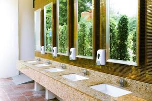 Toilet sink interior of public toilet with of washing hands and mirror golden,clean toilet photo