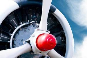 Vintage airplane propeller with radial engine on a beautiful blue sky photo