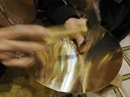 Fez Morocco Metal craftsman making copper trays photo