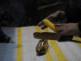 Close up of the threads in a wooden loom in a textile store in Fes, Morocco photo