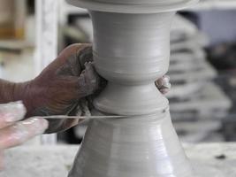 Moroccan Craftsman painting and decorating ceramic products in pottery factory in Fez, Morocco photo