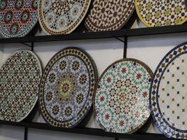 Moroccan mosaic Craftsman painting and decorating ceramic products in pottery factory in Fez, Morocco photo