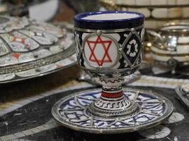 jewish Moroccan Craftsman painting and decorating ceramic products in pottery factory in Fez, Morocco photo