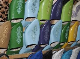 Colorful handmade leather slippers waiting for clients at shop in Fes, next to tanneries, Morocco photo