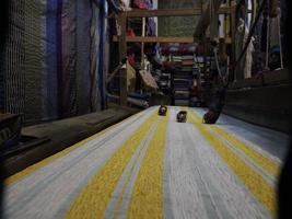 Close up of the threads in a wooden loom in a textile store in Fes, Morocco photo