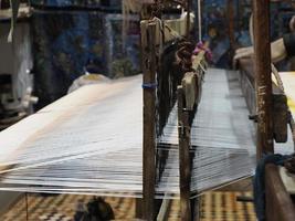 Close up of the threads in a wooden loom in a textile store in Fes, Morocco photo