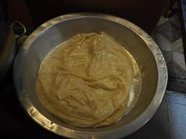 Woman hands kneading dough on an oily table cooking traditional rghayf or msemen, a traditional moroccan bread in Fes medina photo