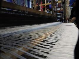 Close up of the threads in a wooden loom in a textile store in Fes, Morocco photo