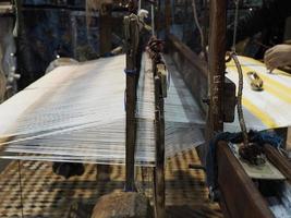 Close up of the threads in a wooden loom in a textile store in Fes, Morocco photo