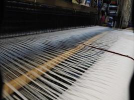 Close up of the threads in a wooden loom in a textile store in Fes, Morocco photo