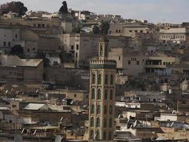 detail of mosque tower Aerial view panorama of the Fez el Bali medina Morocco. Fes el Bali was founded as the capital of the Idrisid dynasty between 789 and 808 AD. photo