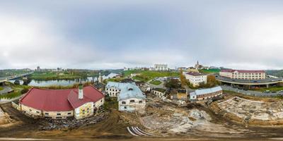 aerial view full hdri seamless spherical 360 panorama over construction site of old abandoned medieval building near bridge across river in equirectangular projection ready for virtual reality VR AR photo