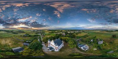 full hdri 360 panorama aerial view of orthodox temple or defense church in countryside with evening sky and sunset clouds in equirectangular projection with zenith and nadir. VR  AR content photo