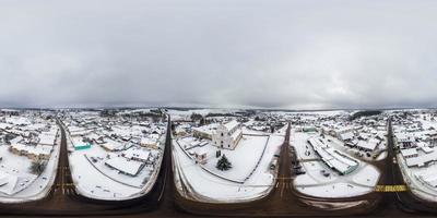 aerial full seamless spherical winter 360 hdri panorama view overlooking small village with church over crossroads in equirectangular projection in snowfall photo