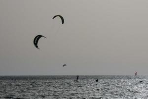 windsurfing, kitesurfing, water and wind sports powered by sails or kites photo