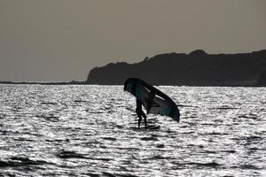 windsurfing, kitesurfing, water and wind sports powered by sails or kites photo