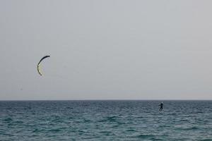 windsurfing, kitesurfing, water and wind sports powered by sails or kites photo