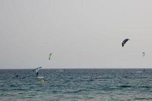 windsurfing, kitesurfing, water and wind sports powered by sails or kites photo