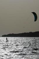 windsurfing, kitesurfing, water and wind sports powered by sails or kites photo