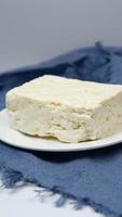 A plate with white cheese on blue cloth video