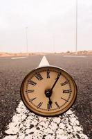 Clock on the road photo