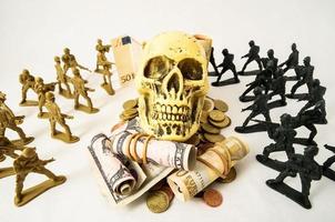 Toy soldiers with a skull and banknotes photo