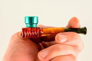 Hand holding a pipe photo