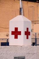 Red cross on a concrete block photo