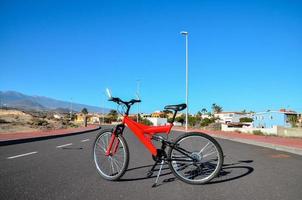 Red bicycle on the road photo