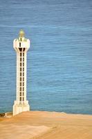 Lighthouse by the sea photo