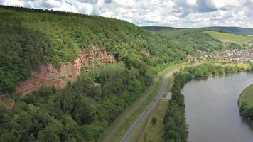 Drone video of the Main River with the wine village Dorfprozelten during the day