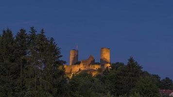 Time-lapse video of medieval castle illuminated during dusk