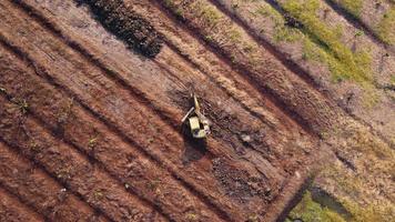 Excavator dig ground at construction site. Aerial view of a wheel loader excavator with a backhoe loading sand into a heavy earthmover. Excavator digging soil pits for the agricultural industry. video