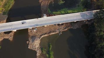 Aerial view of renovation and repair work on the river bridge road. video