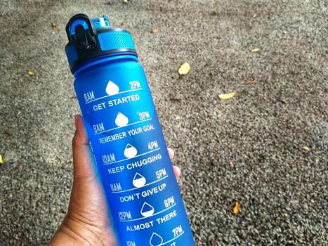 Bandung City, West Java, Indonesia 2023 a hand holding a drinking bottles for health. Avoid dehydration photo