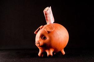 Piggybank on black background photo