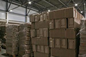 Storage warehouse with packaged goods on wooden pallet at recycle paper factory. Preparation shipment of products. Logistics, transportation and distribution facility for delivery. Supply chain cargo photo