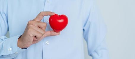 man hand holding red heart shape. love, donor, world heart day, world health day and Insurance concepts photo