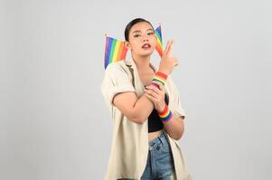 Pretty woman LGBQ pose with mini muli-color flag photo