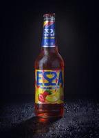 KRASNOYARSK, RUSSIA - OCTOBER 21, 2022 Misted bottle of ESSA beer on a black background. Fruit beer. photo