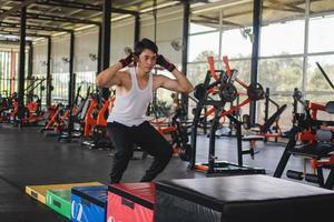 Man athletes exercising jump on crates during gym training in the gym photo