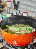 Finished bouquet of greens is placed in saucepan for dressing the dish. photo