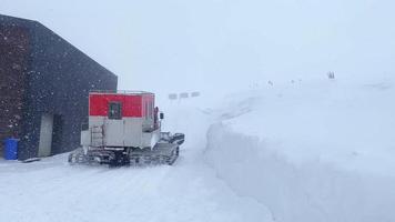 Snowcat with cabin to take skiers snowboarders freeride downhill in remote caucasus mountains. Ratrak in video