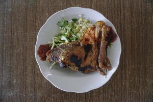 Traditional Fried chicken with veggies from Indonesia photo