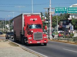 Puerto Escondido Oaxaca Mexico 2023 Red Coca Cola trucks cargo transporter delivery cars in Mexico. photo