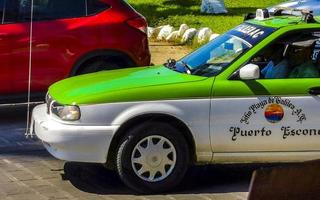 Puerto Escondido Oaxaca Mexico 2023  Green colorful taxi cab car in Puerto Escondido Mexico. photo