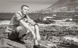 Male model tourist traveler coast landscape Cape Town South Africa. photo