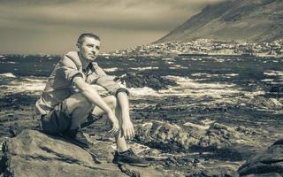 Male model tourist traveler coast landscape Cape Town South Africa. photo